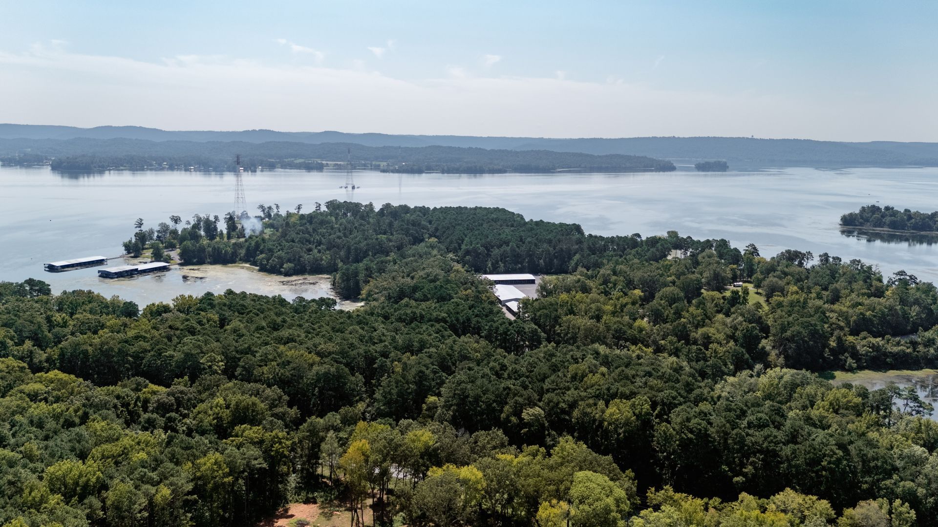 An aerial view of a large body of water surrounded by trees.