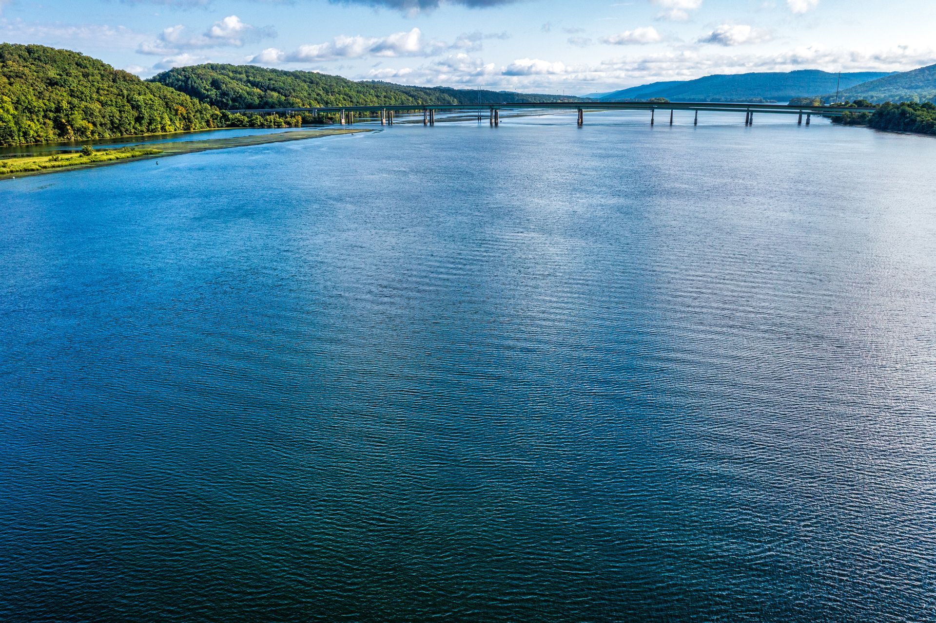 A large body of water with a bridge in the background