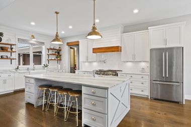 A close-up view of a multi-core electrical cable with three exposed, copper-stranded wires: brown, yellow-green, and blue.