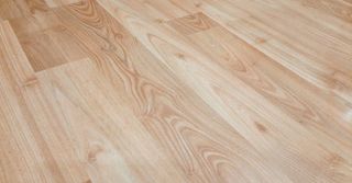 A close up of a wooden floor in a room.