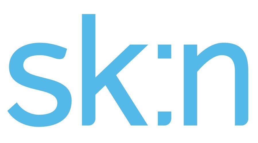 A conference room with a large white table and chairs