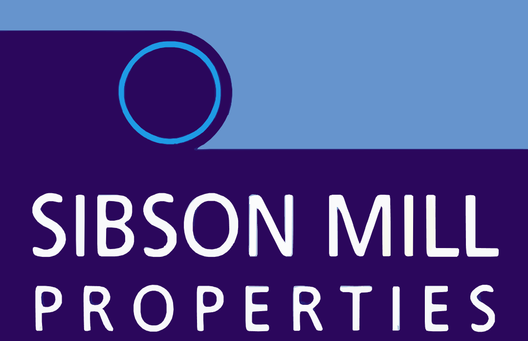 A conference room with a large white table and chairs