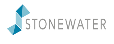 A group of men are standing around a table and chairs on a patio.