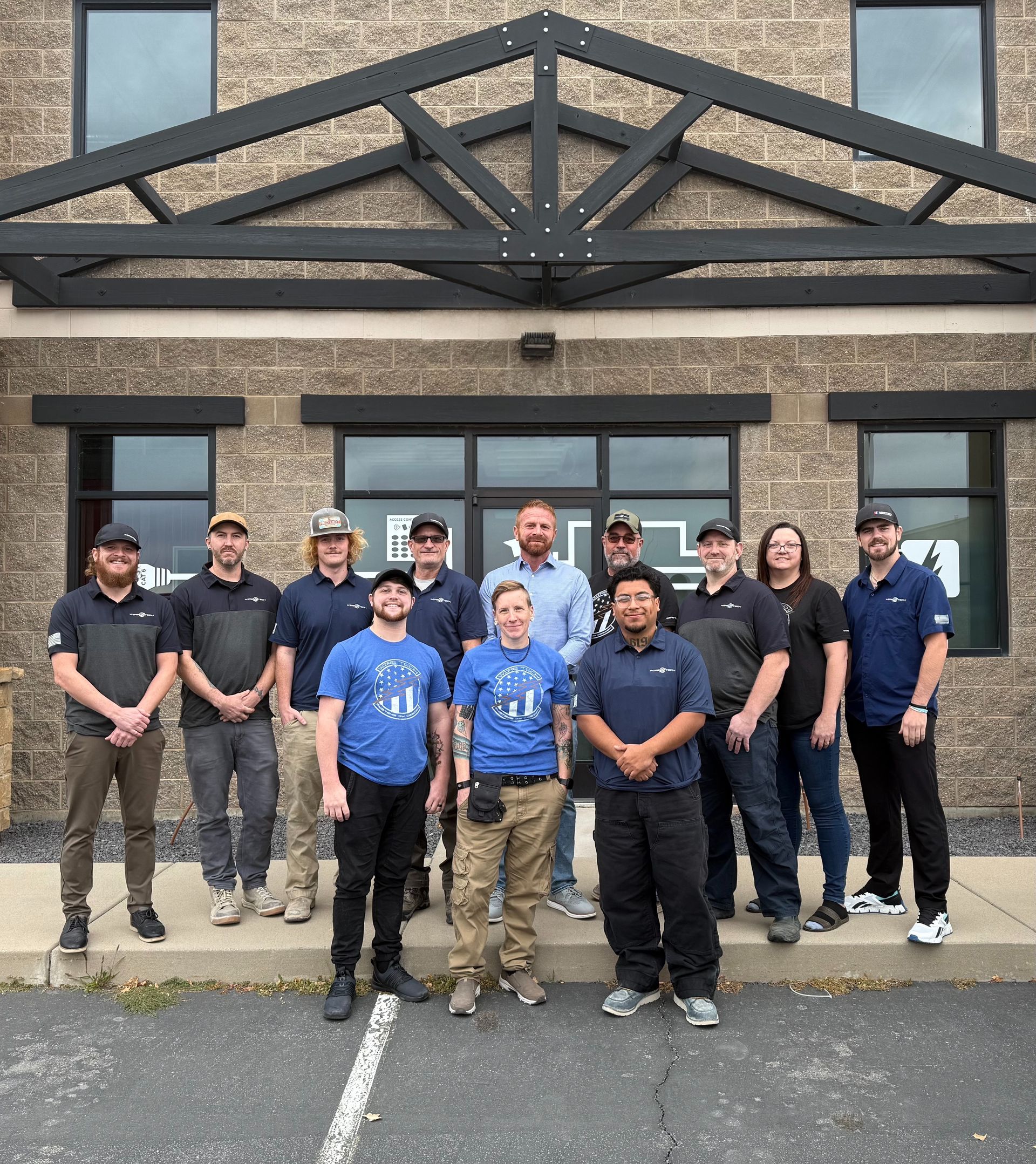 WireTech team posing in front of a building with a black awning