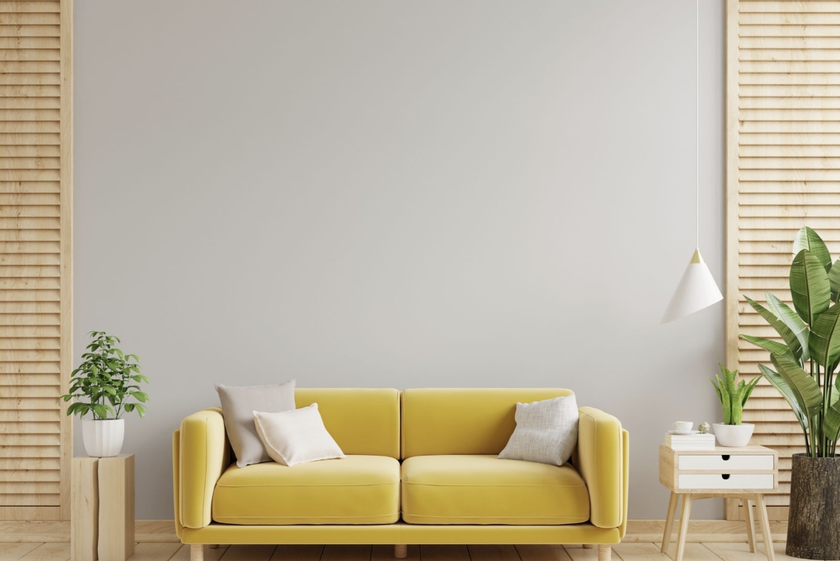 Yellow sofa against a gray wall, flanked by wooden screens and plants in a modern living room.