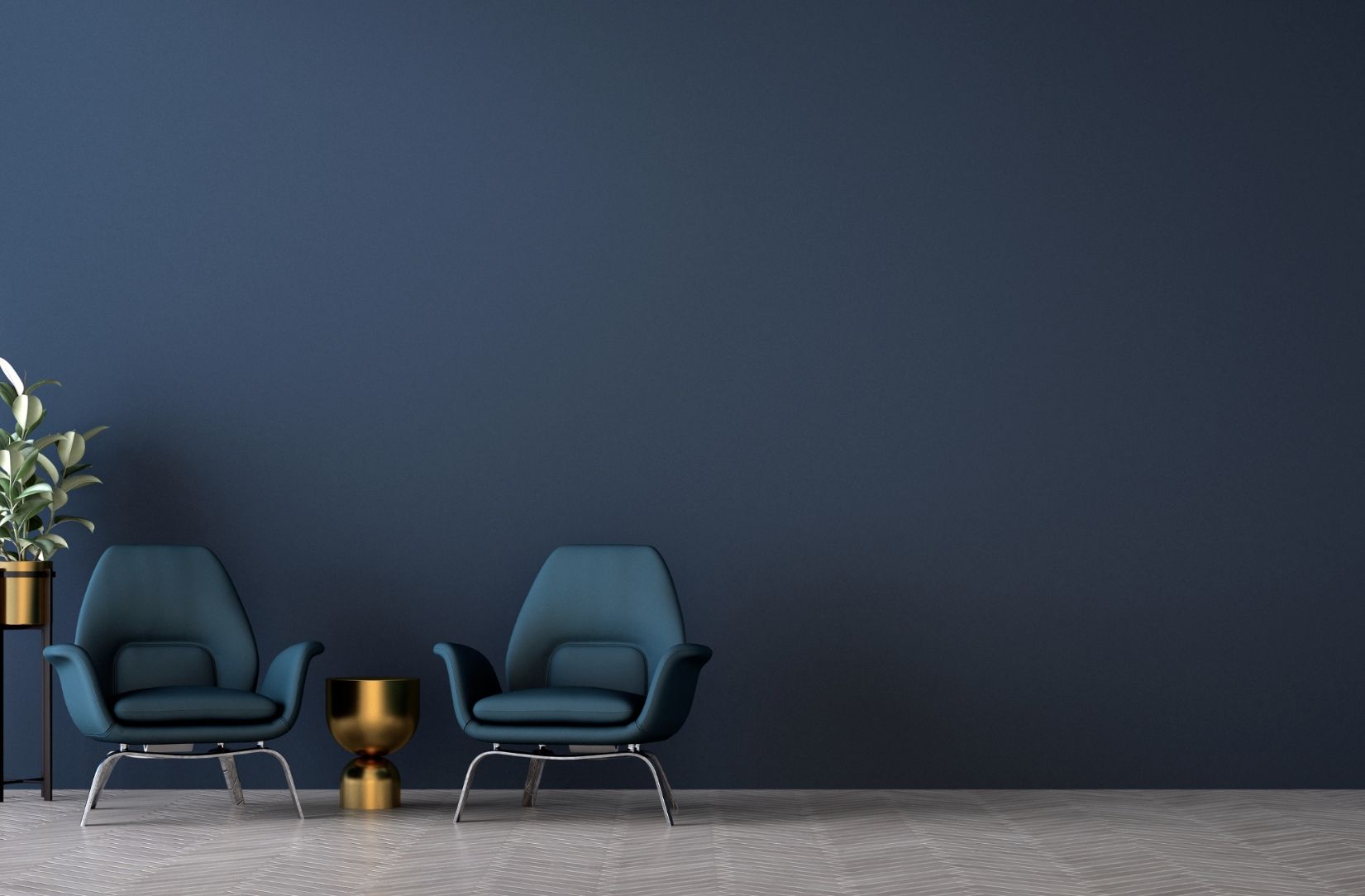 Two teal armchairs and a gold table against a dark blue wall.