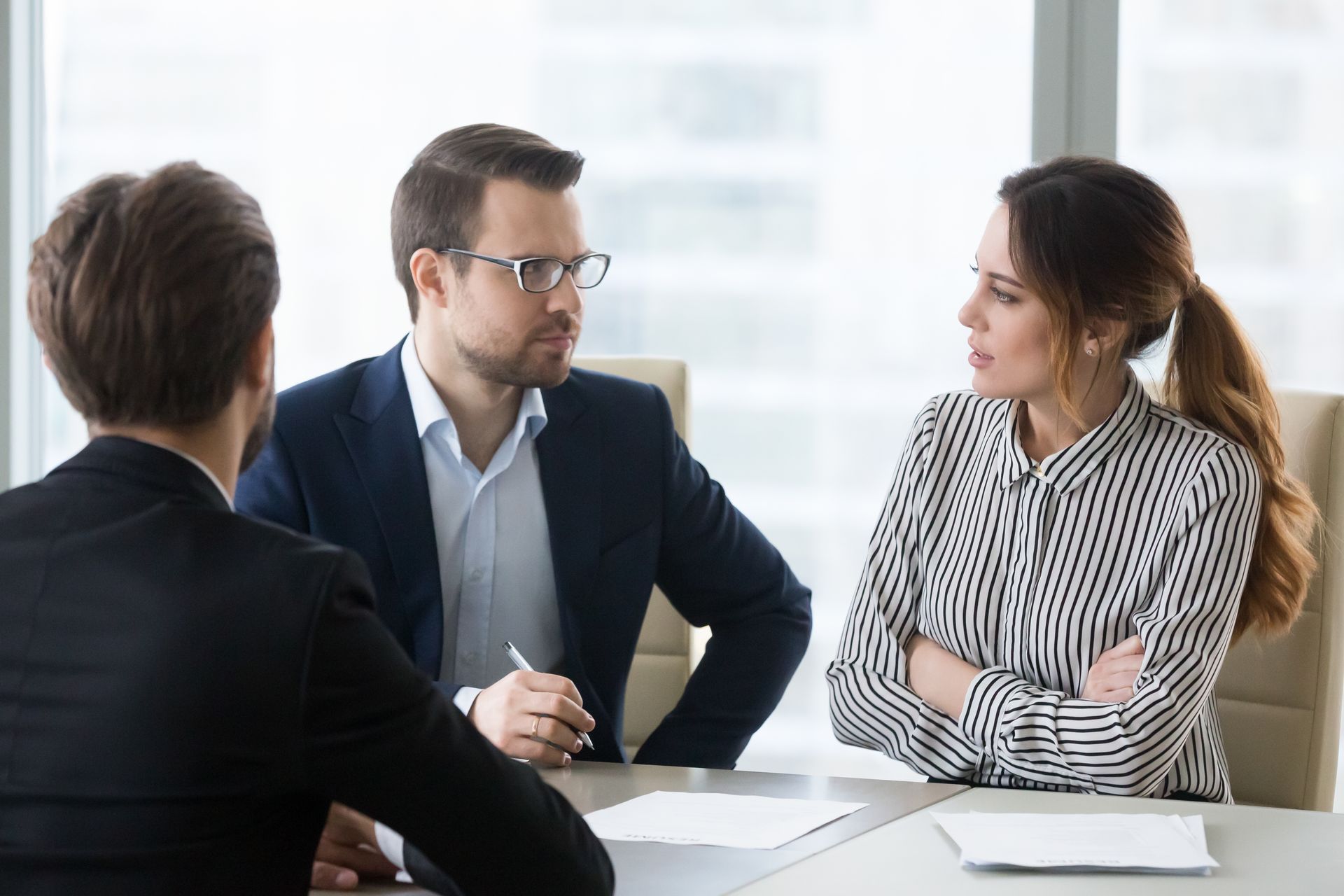 Three Professionals in Business Attire Sit at a Table in a Bright Office — Australian Employee Lawyers in Broadbeach Waters, QLD