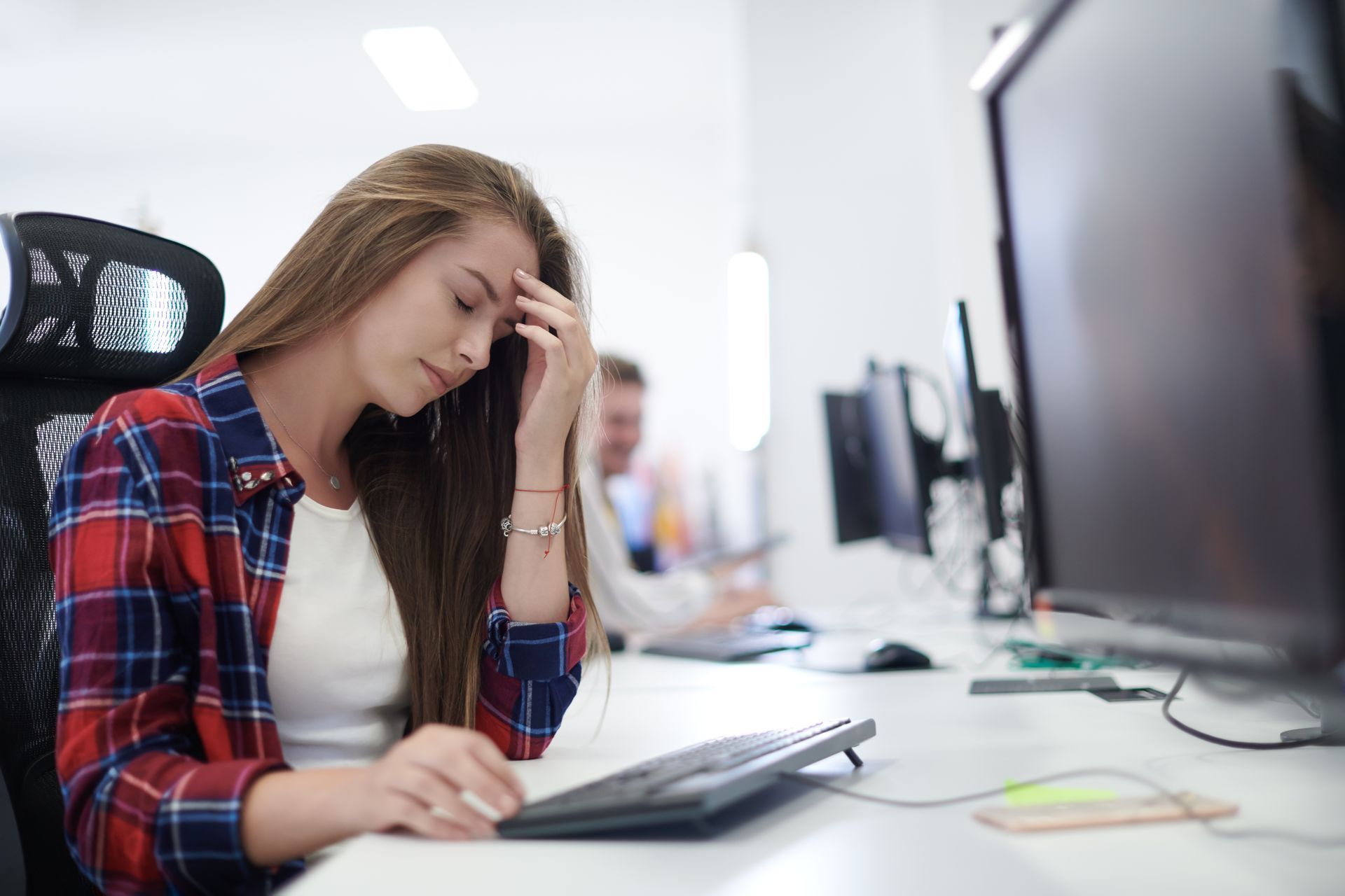 Employee Sits at a Desk in an Office Stressed About Their Salary — Australian Employee Lawyers in Broadbeach Waters, QLD