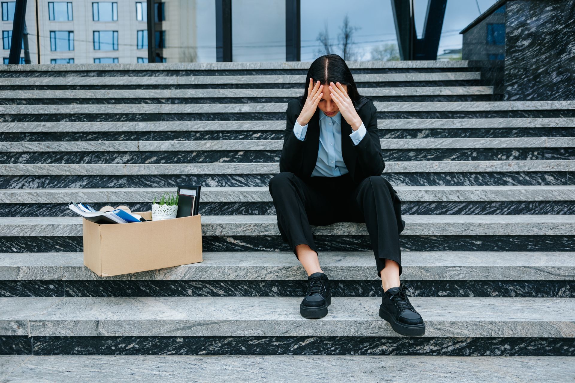 Employee Sits on Outdoor Stone Stairs — Australian Employee Lawyers in Broadbeach Waters, QLD
