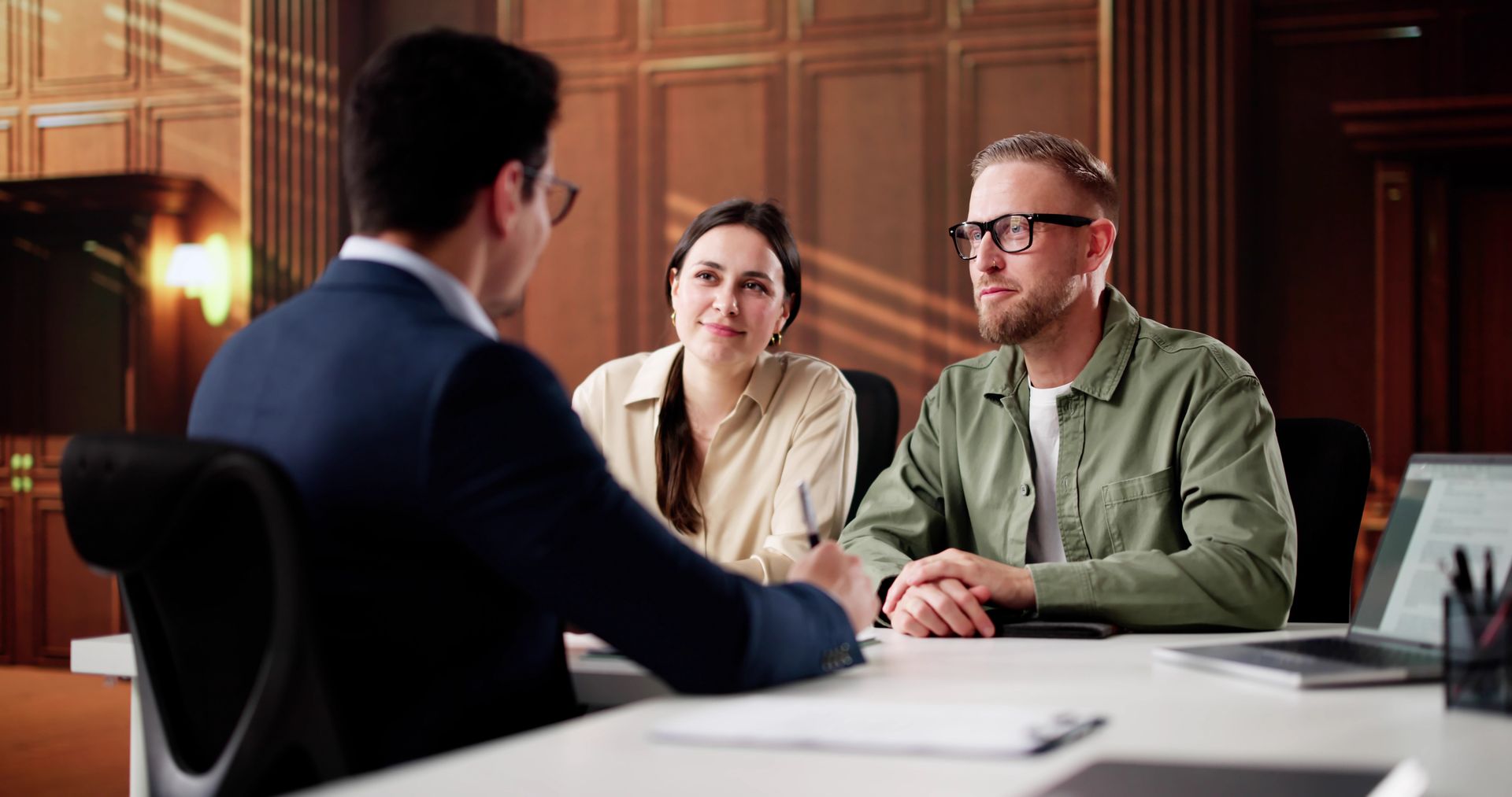 A Professional Consultant Sits at a Desk Across From Two Employee — Australian Employee Lawyers in Broadbeach Waters, QLD