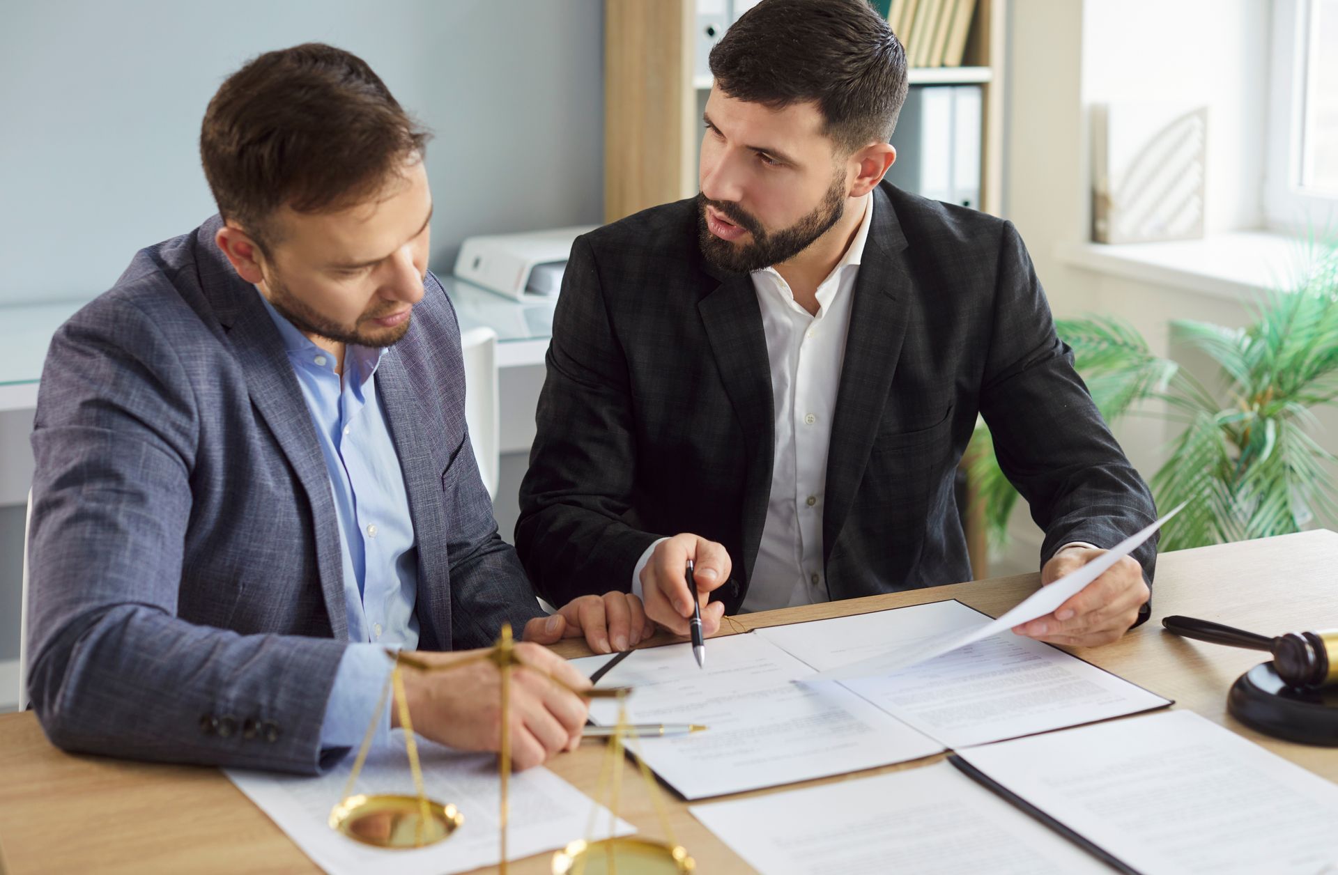 Lawyer and Employee Discuss Documents at an Office Desk — Australian Employee Lawyers in Broadbeach Waters, QLD