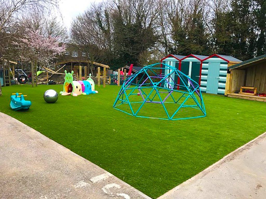 Peterborough nursery playground with artificial grass underneat climbing frame