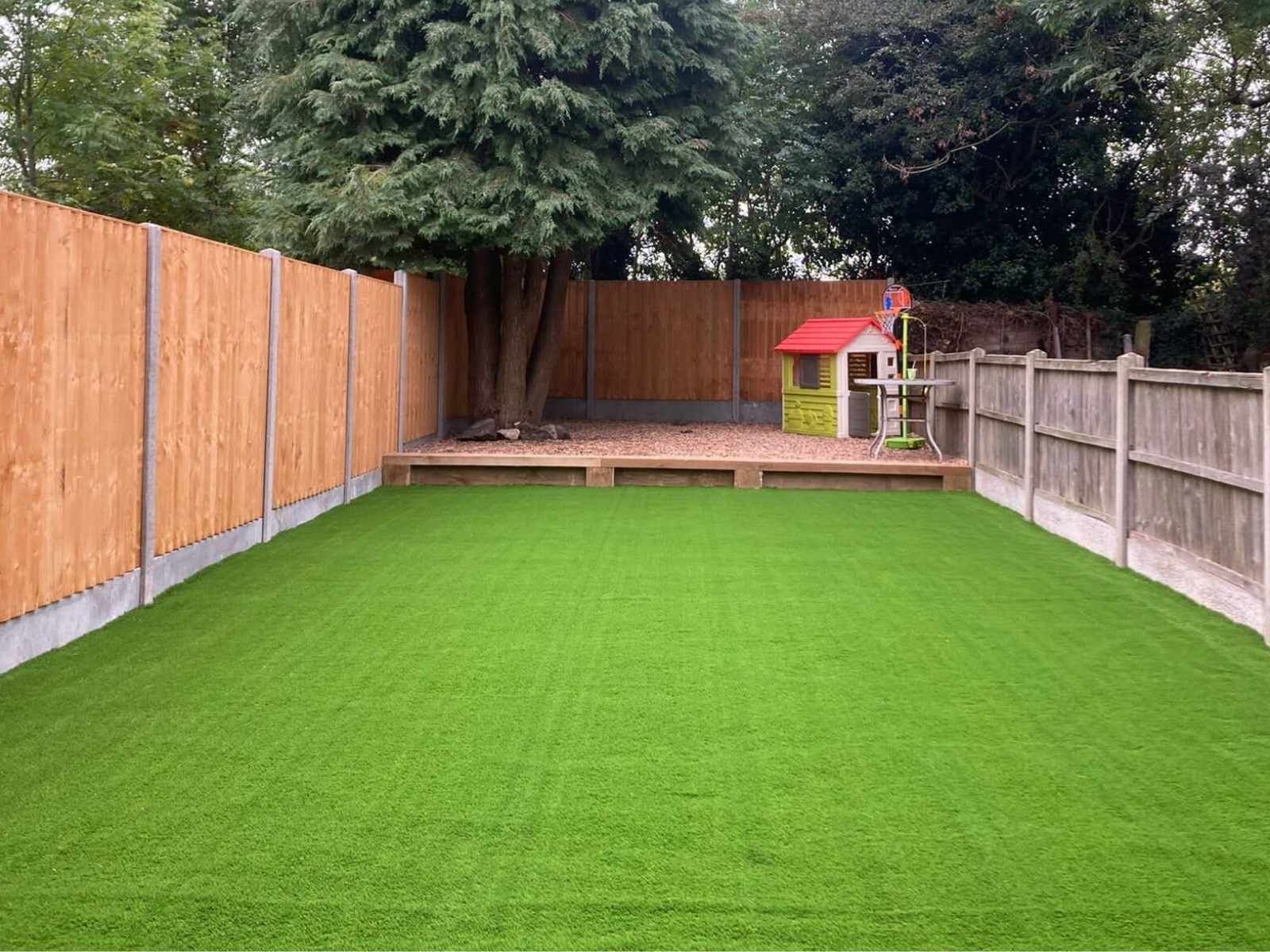 Bespoke Artificial Grass Peterborough completed artificial lawn installation including additional decking at the back of the garden