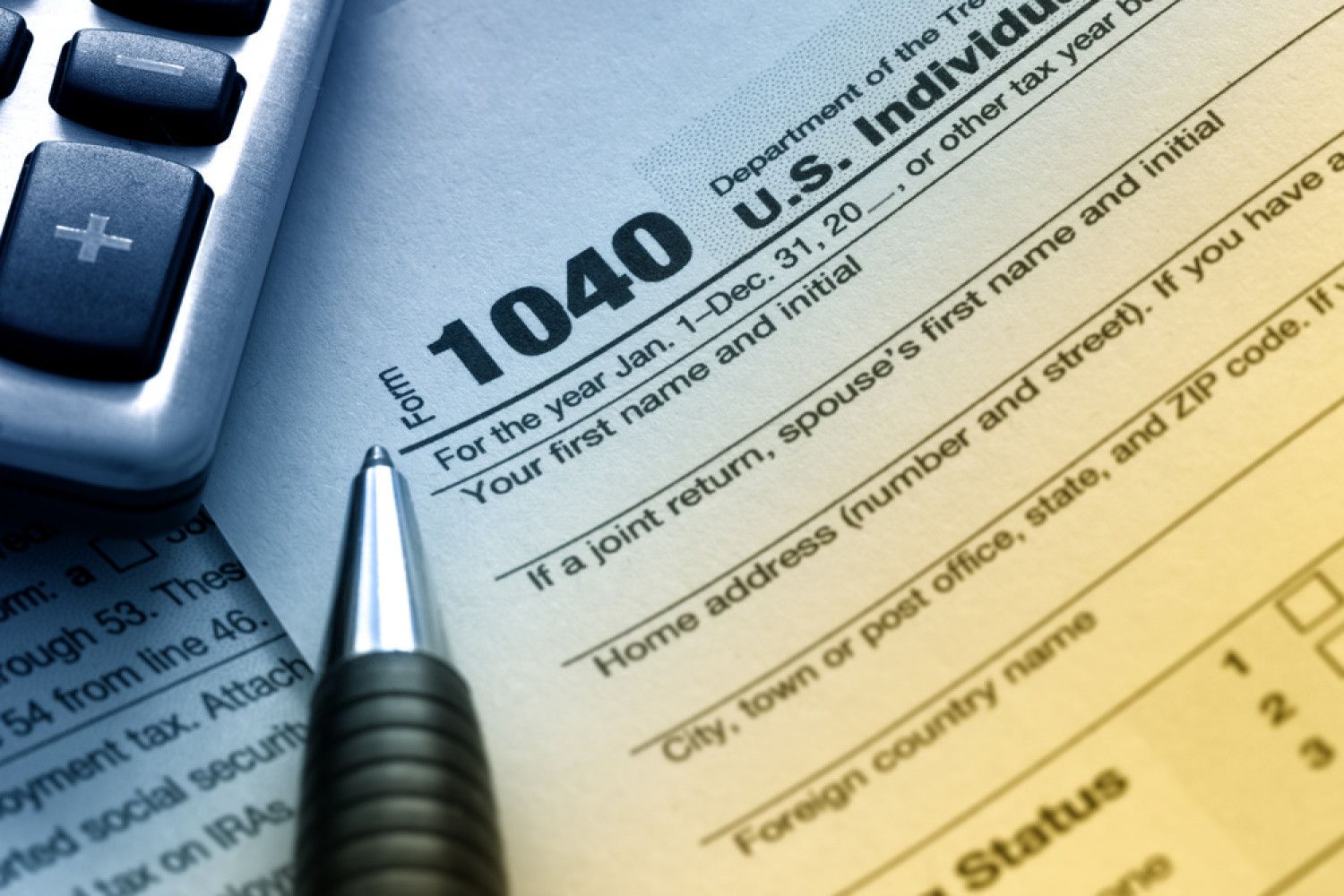 A pen is sitting on top of a 1040 tax form
