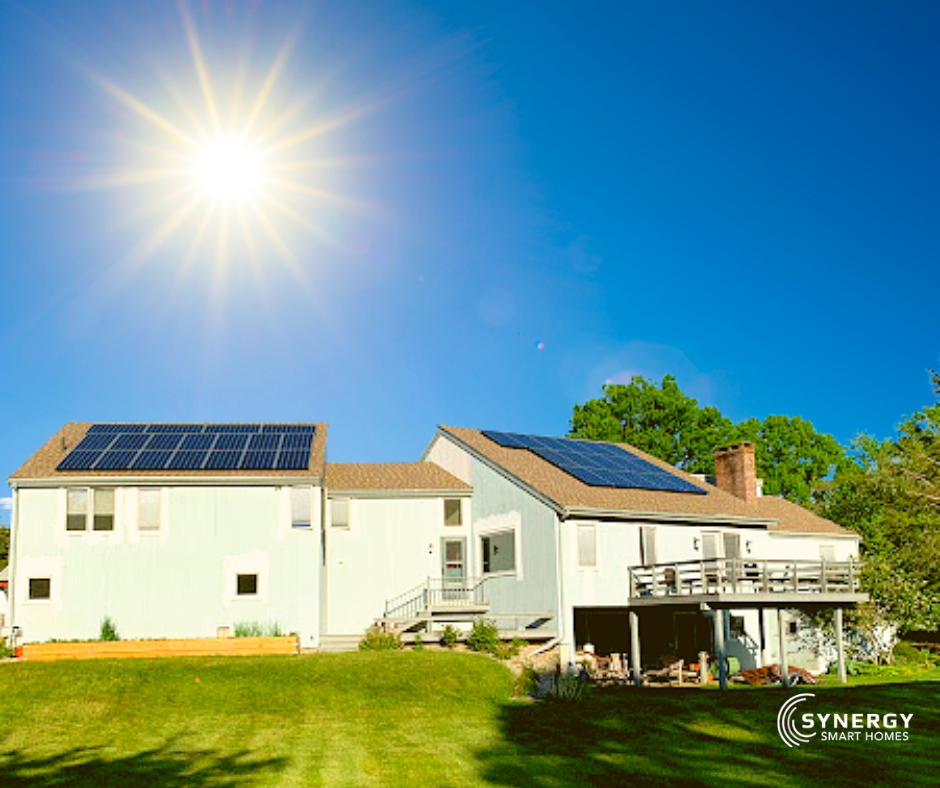 A white house with solar panels on the roof