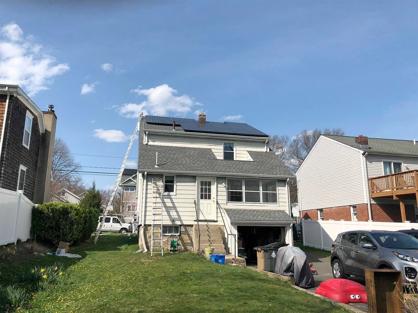 The back of a house with solar panels on the roof.
