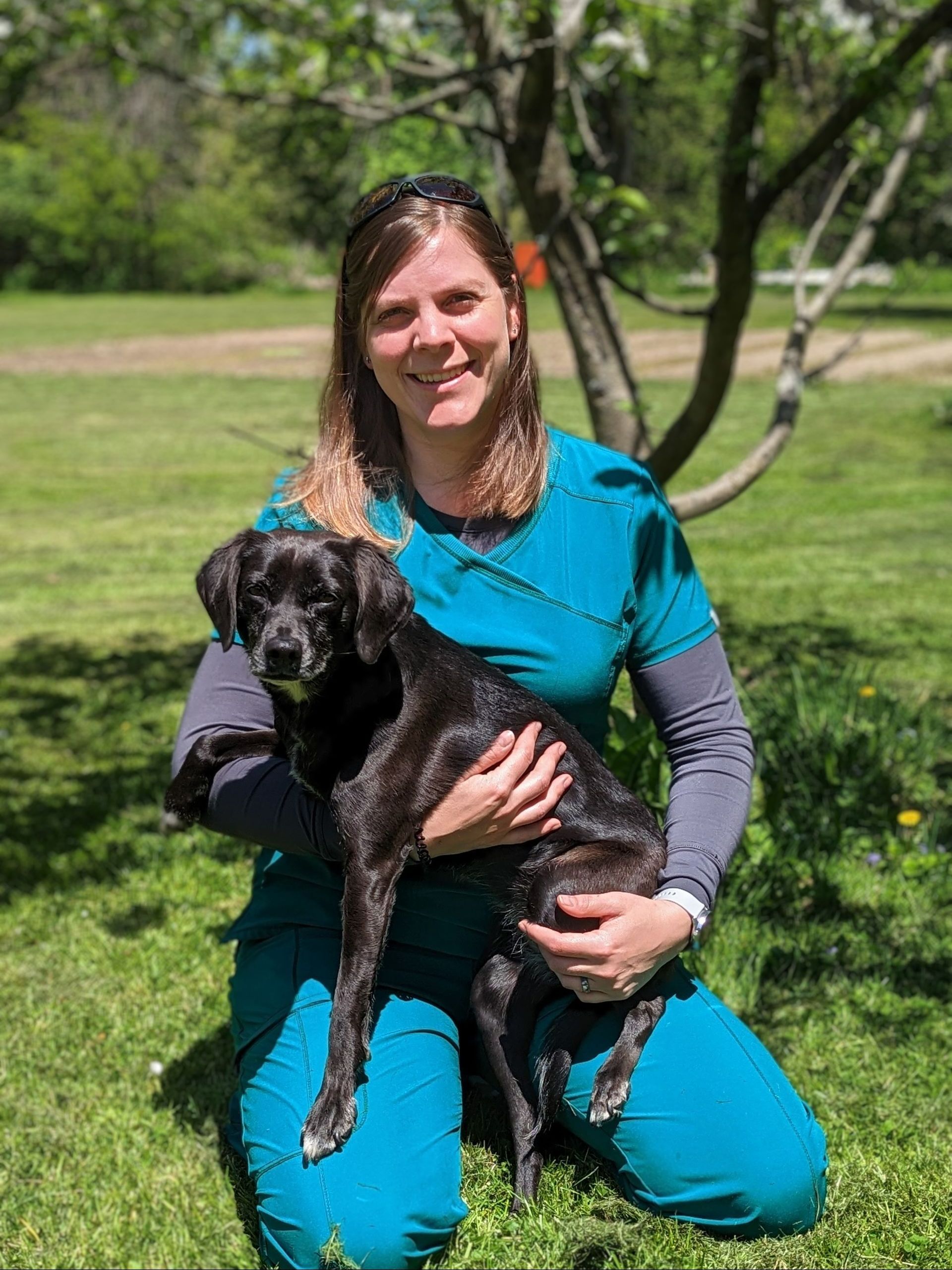 Laura Welsted with a Black Dog - Montrose, PA - Town & Country Veterinary Services