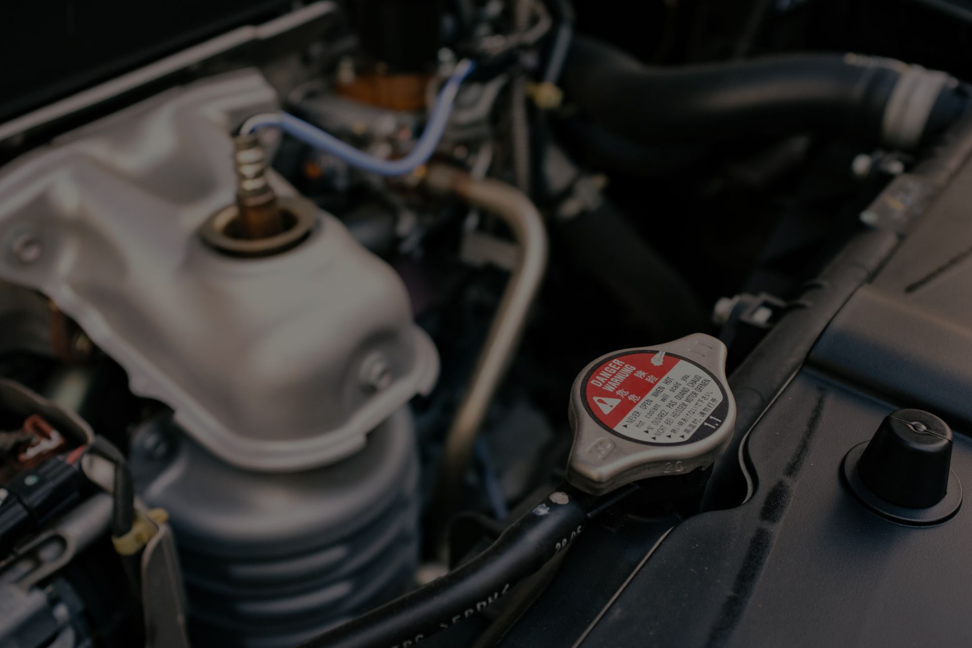 Car engine with radiator cap in focus. | Importsports