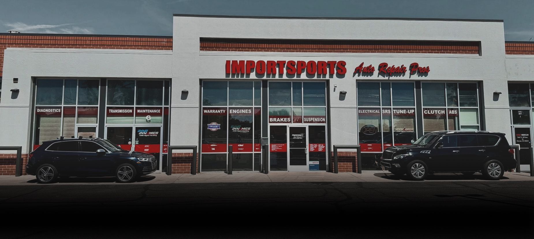 Exterior of Importsports Auto Repair shop with a yellow sports car and a white wagon parked out front. | Importsports