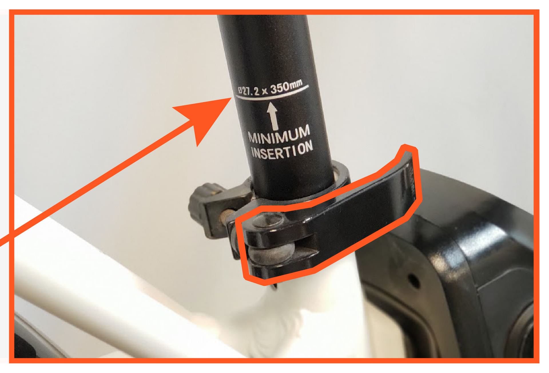 A close up of a bicycle seat post with an arrow pointing to it.