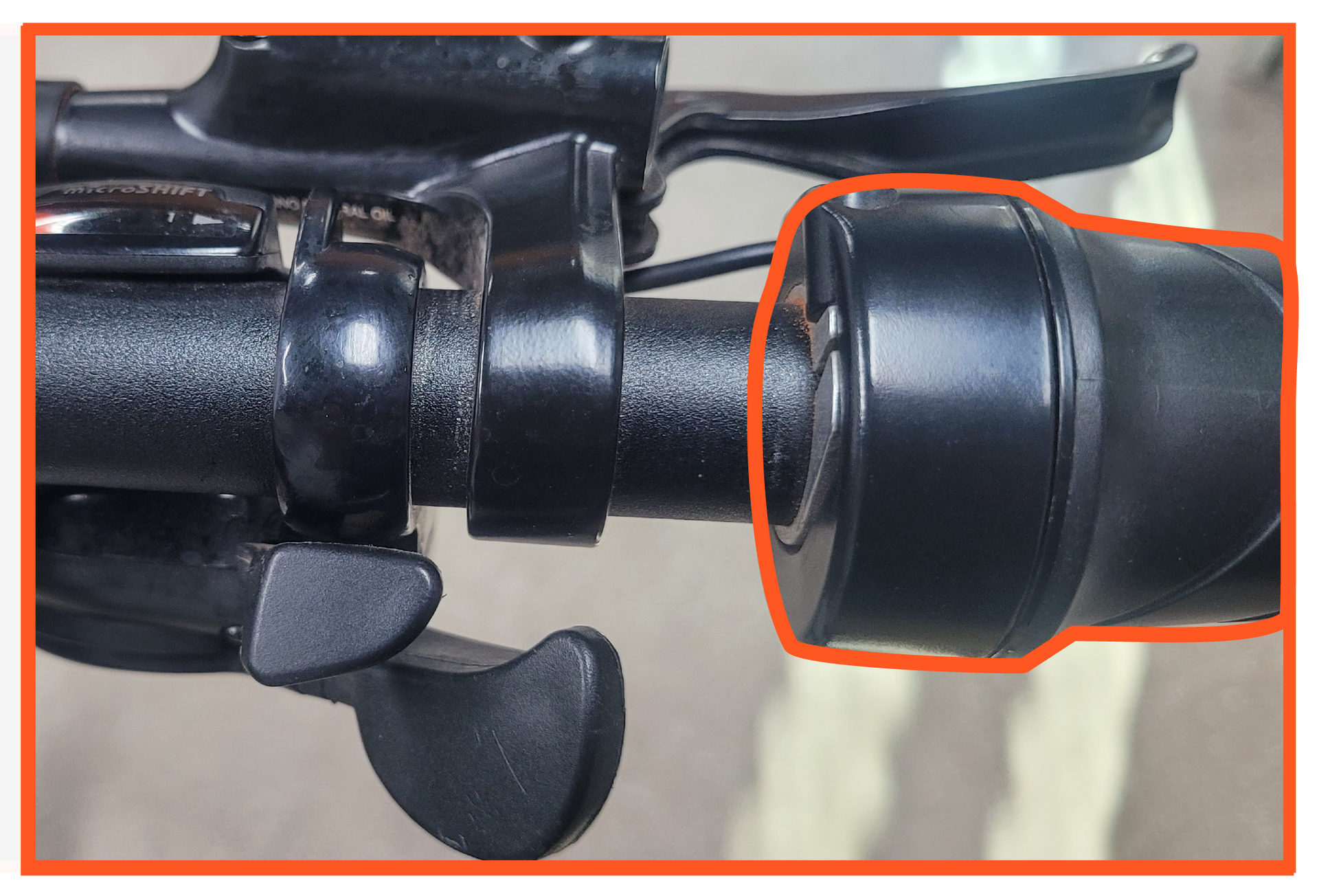 A close up of a bicycle handlebar with a red circle around it.