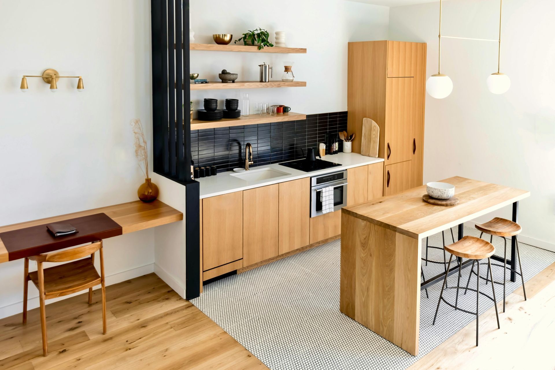Modern kitchen with wood cabinets, a breakfast bar, and a work desk.