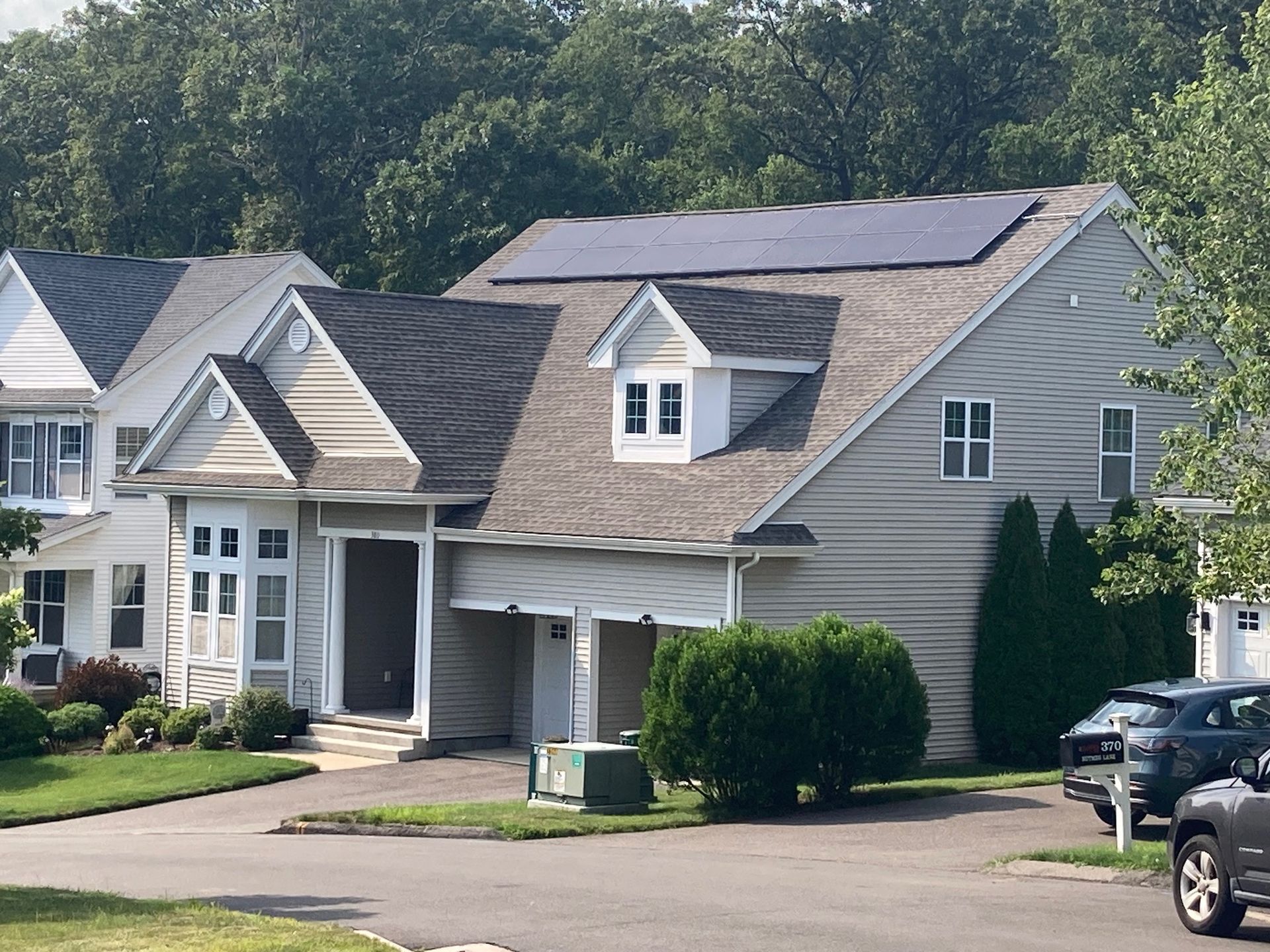 A row of houses with solar panels on the roof