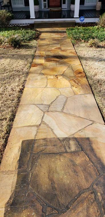 A stone walkway leading to the front door of a house.