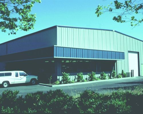 A White Truck Is Parked in Front of A Large Building - Redmond, WA - Commercial Industries