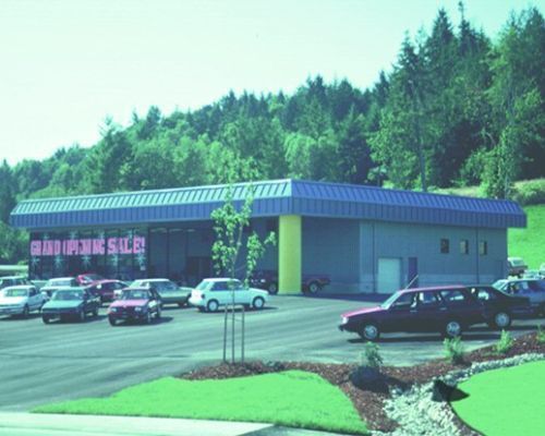 Cars Are Parked in Front of A Building that Says Grand Opening Sale - Redmond, WA - Commercial Industries