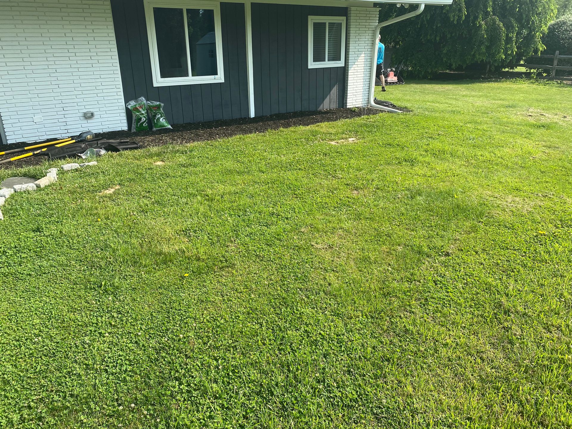 A house with a lush green lawn in front of it.