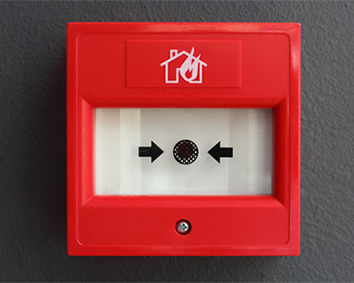 A red fire alarm with arrows pointing to the left and right