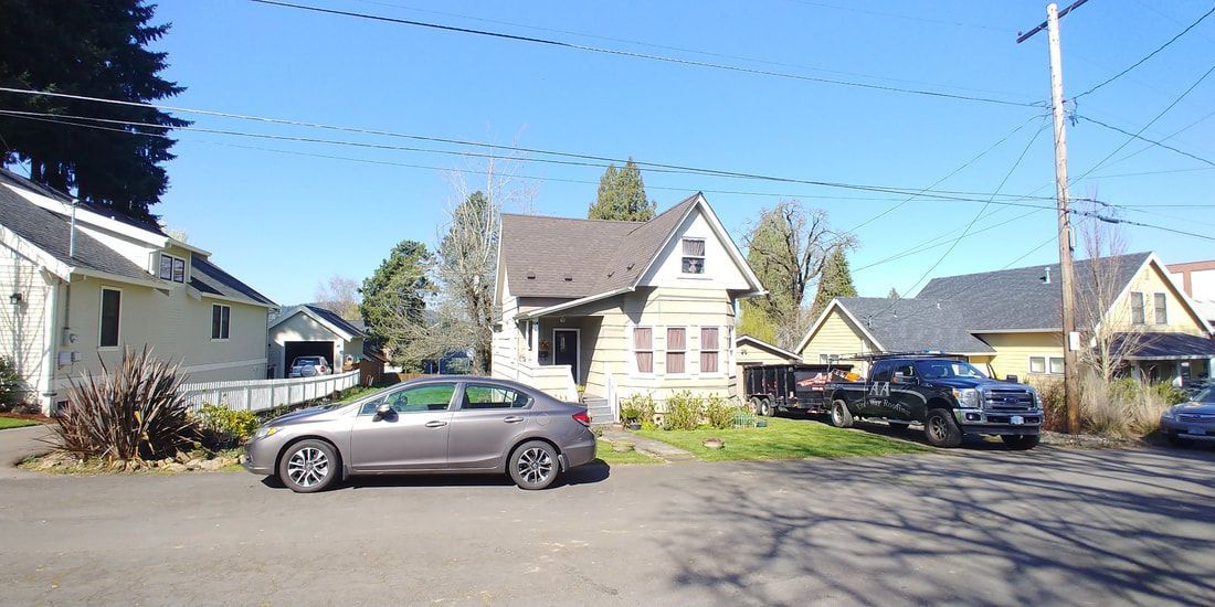 Houses and cars on a sunny day in a residential neighborhood.