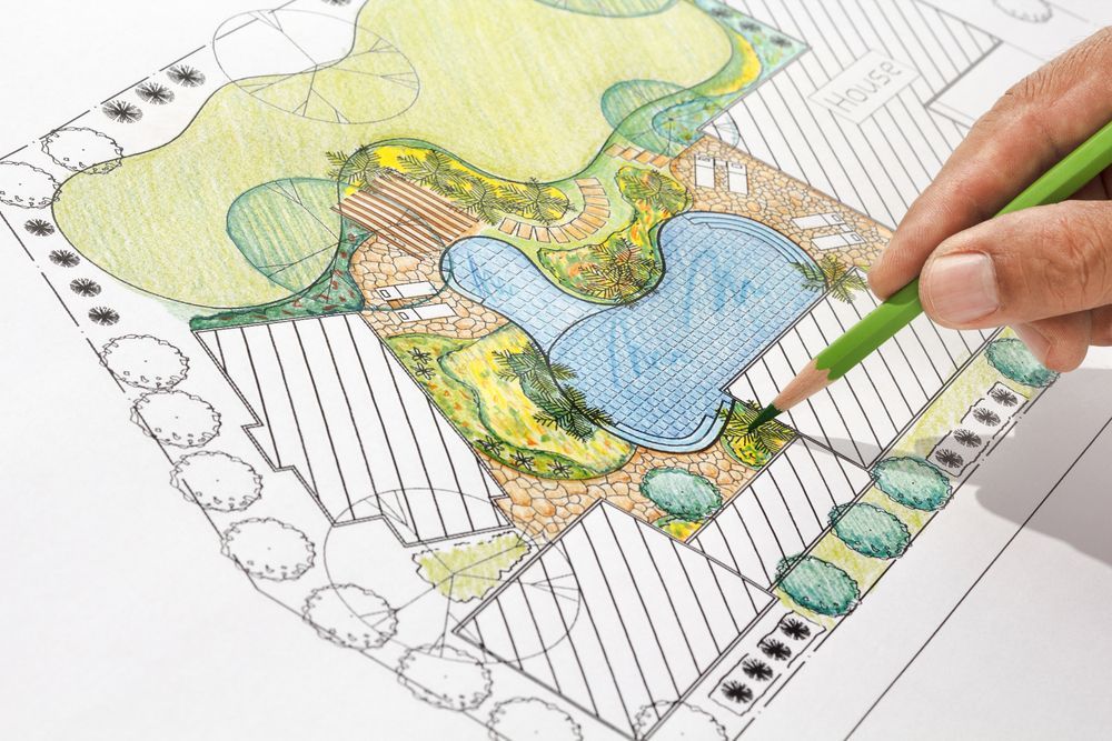Una persona sta disegnando un paesaggio con una matita verde.