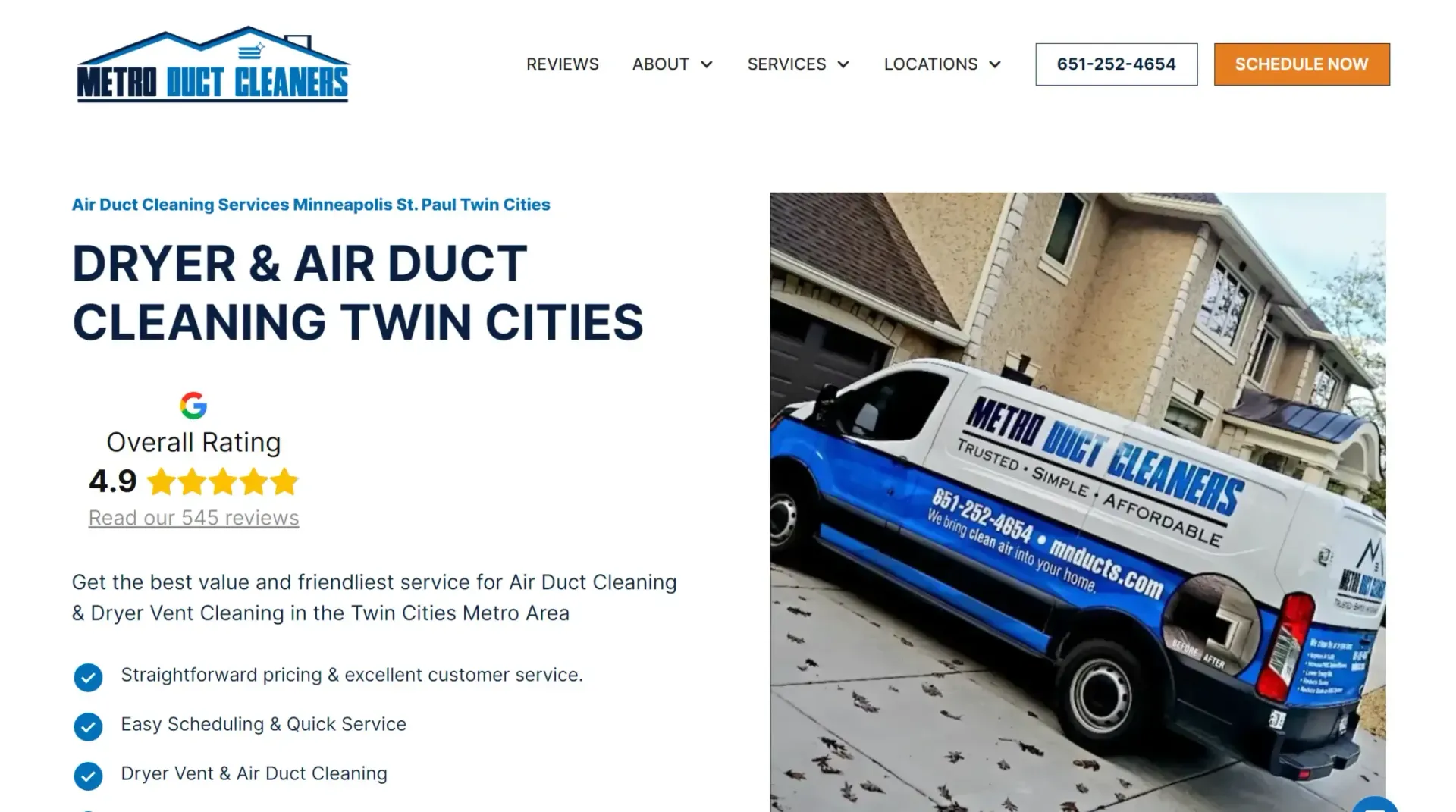A blue and white van is parked in front of a house.