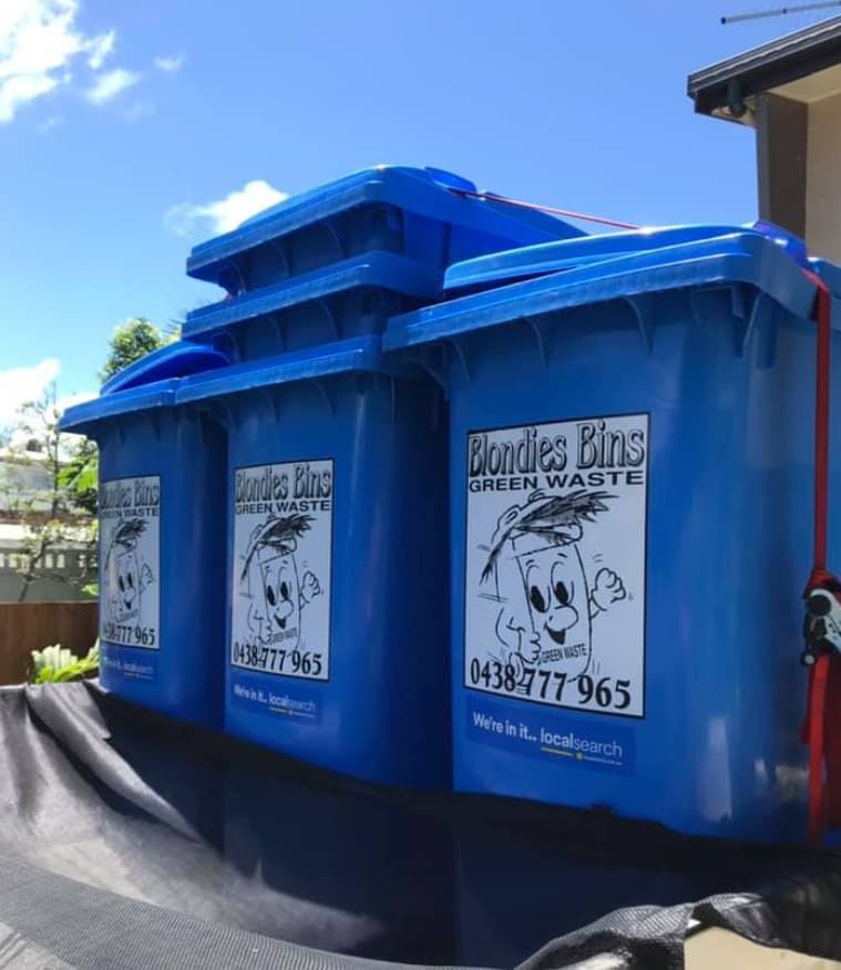 A Green Trash Can Filled With Leaves And Branches — Blondies Bins in East Mackay, QLD