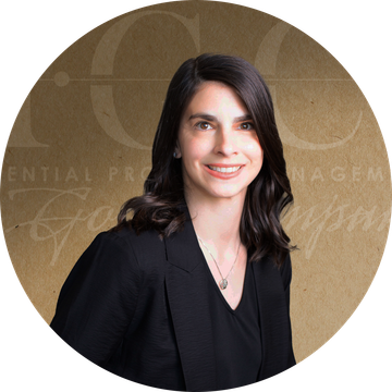 Woman in black blazer smiles, set against a brown background with text.