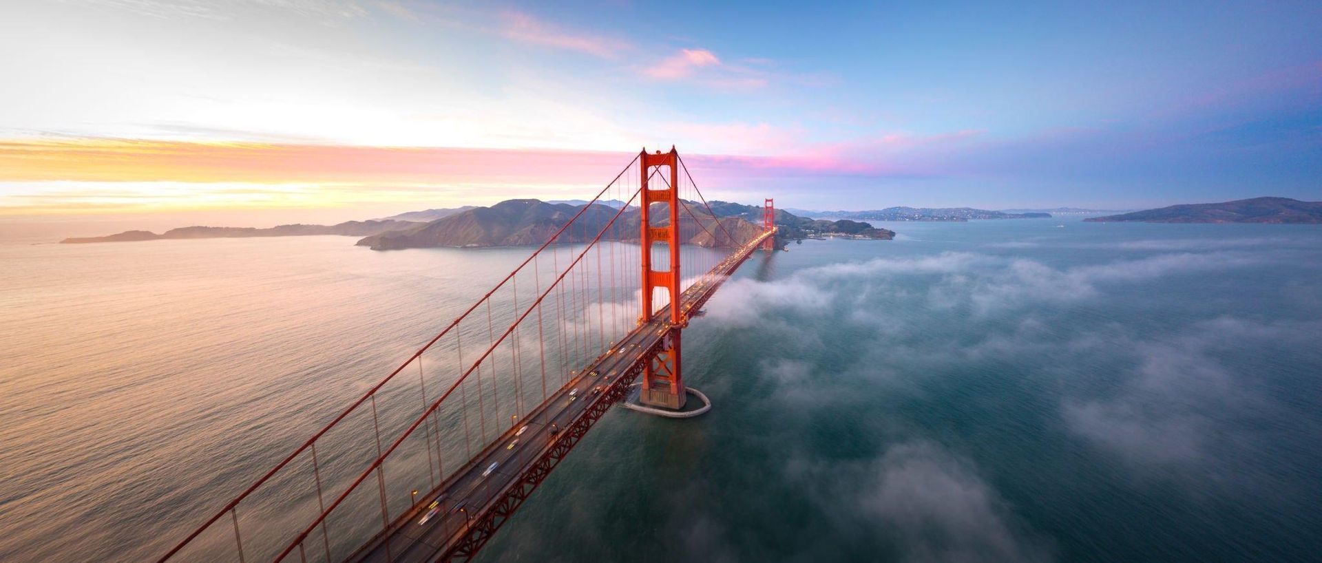 An aerial view of the golden gate bridge in san francisco at sunset.