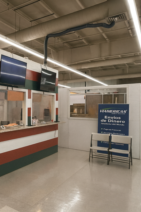 Tan commercial building with a blue sign that reads 