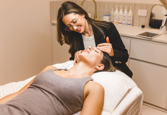 Tijan assessing a client's face