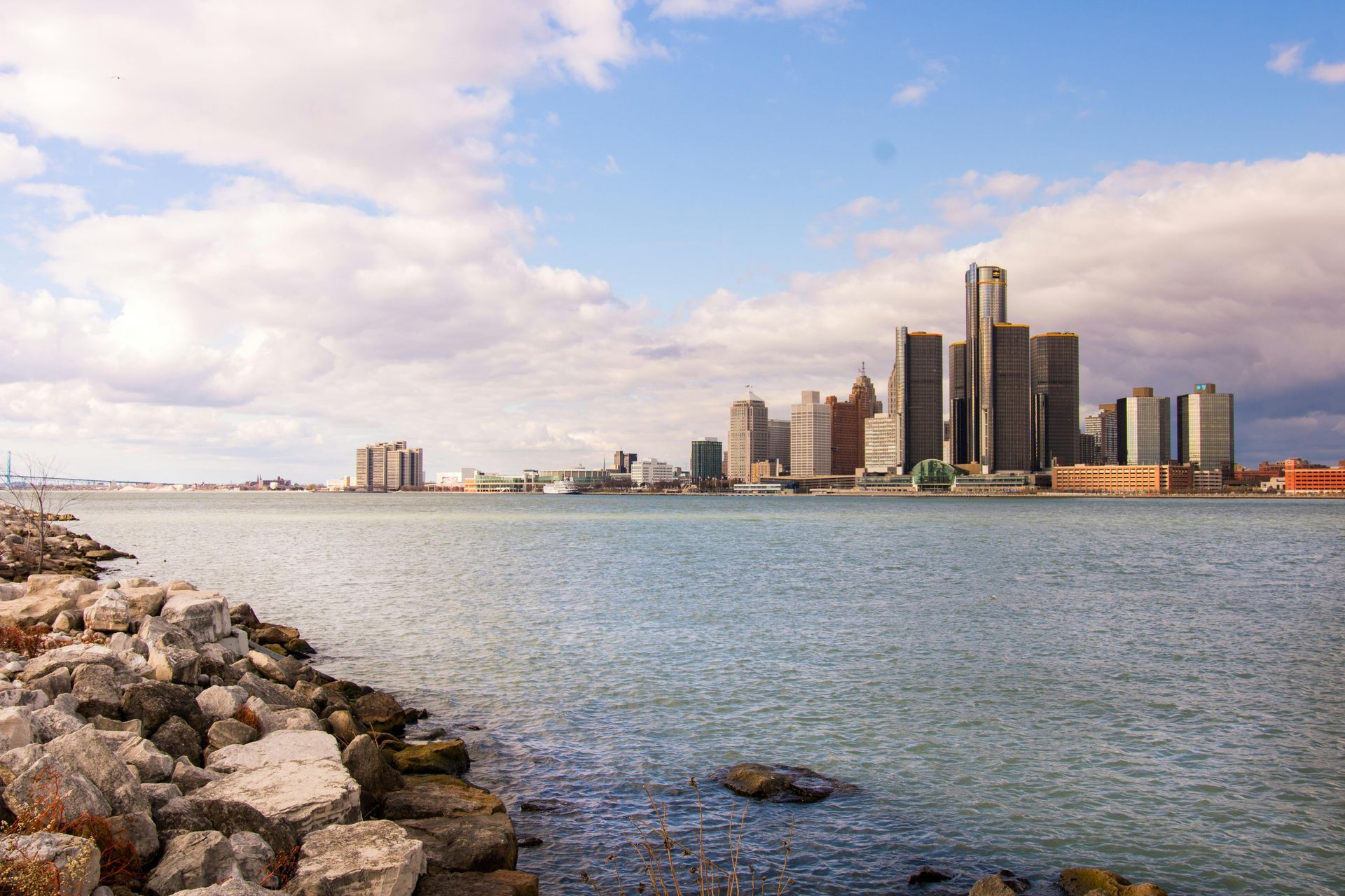 A city skyline is visible over a body of water.