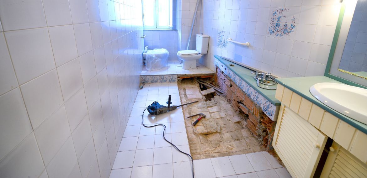 A bathroom is being remodeled with a hole in the floor.