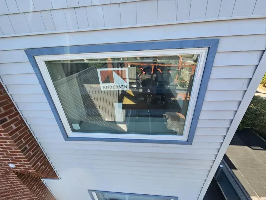 An aerial view of a house with a square window on the side.