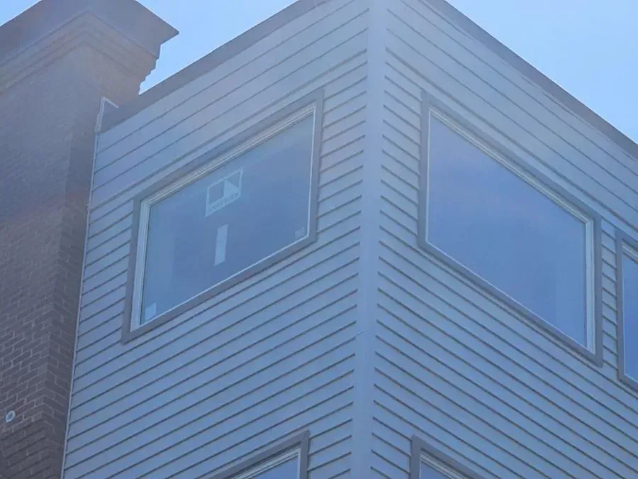 The corner of a building with a lot of windows