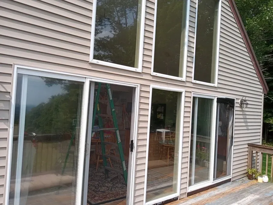 A house with a lot of windows and sliding glass doors