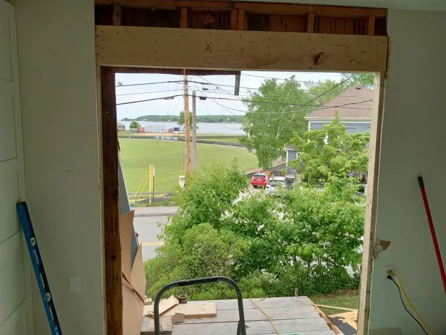 A window in a room with a view of a lake and trees