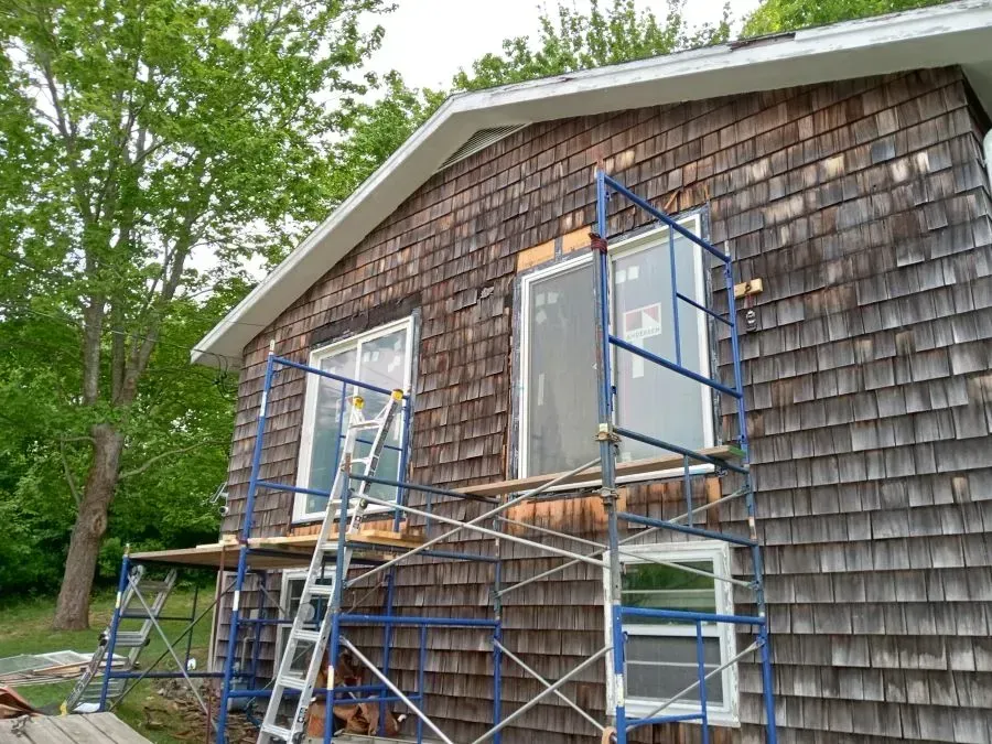 A house with a blue scaffolding on the side of it