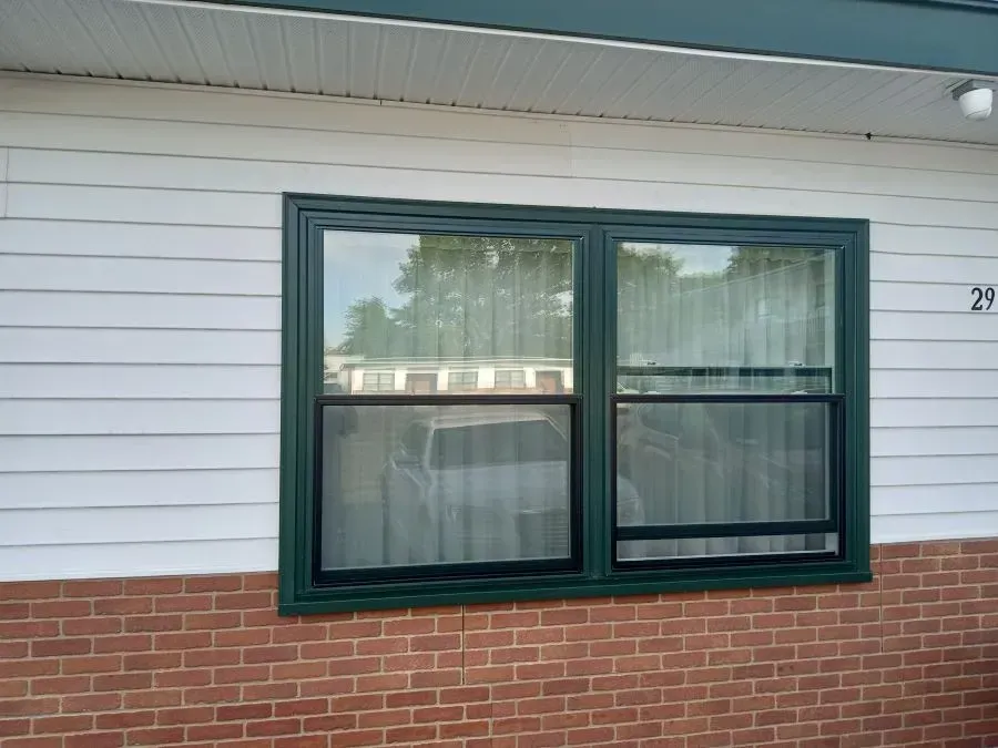 A window on the side of a house with the number 29 on it