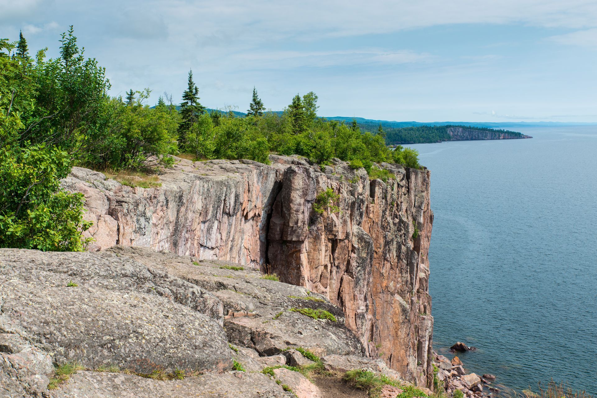 A large rocky cliff overlooking a body of water.