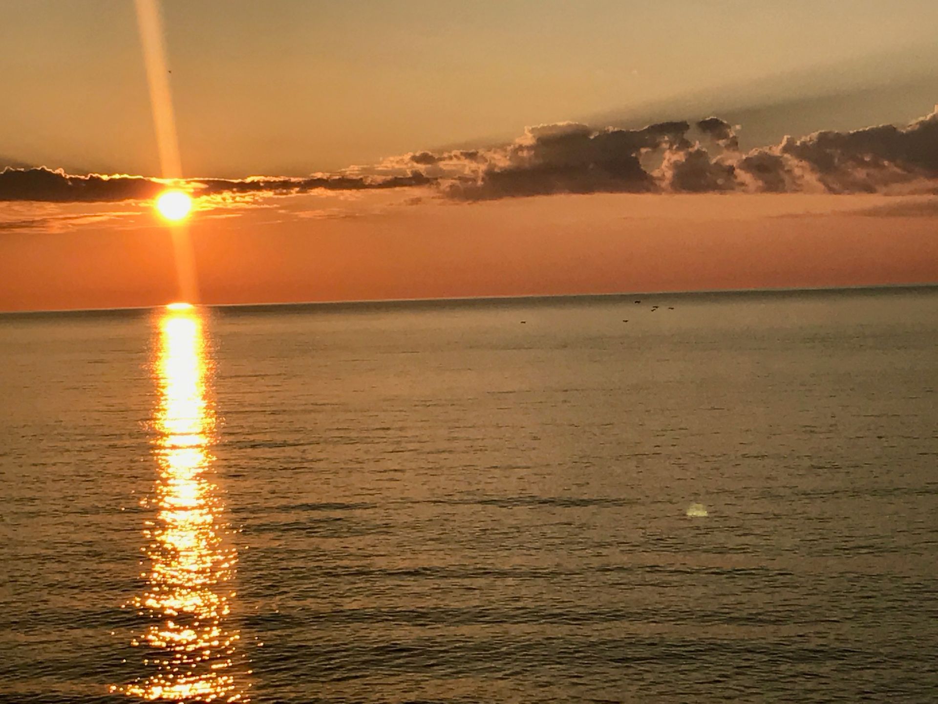 The sun is setting over a body of water